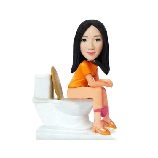 Custom Made Bobble Heads Sitting On The Toilet